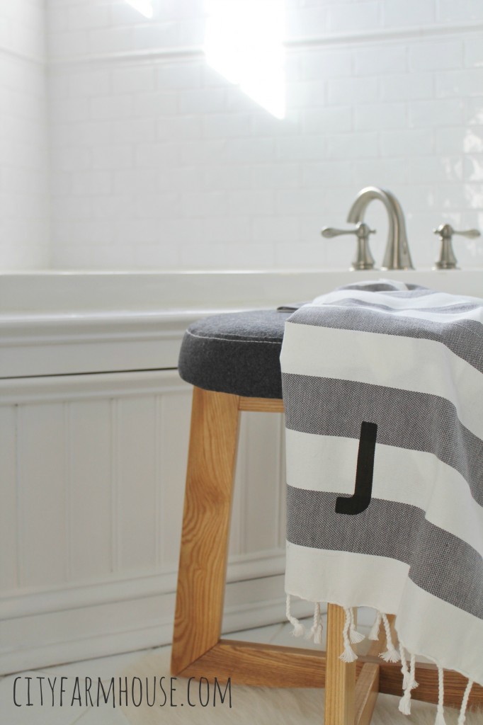 Adding texture to an all white bathroom, fleece stool from Target-City Farmhouse