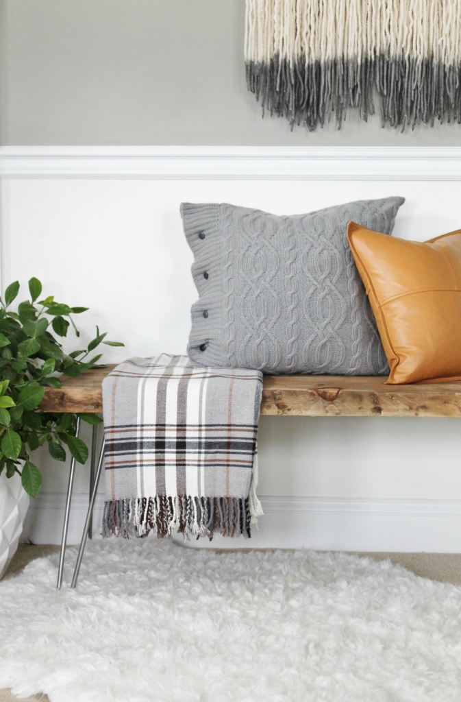 simple modern farmhouse holiday bedroom. Christmas decorating. Pine cone wreath, fresh greenery, plaid & cozy details