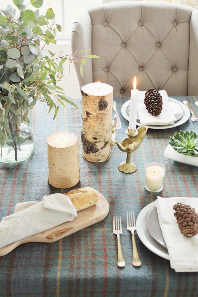 holiday-table-rustic-cozy-simple-wool-plaid-throw-birch-candles-pine-cones