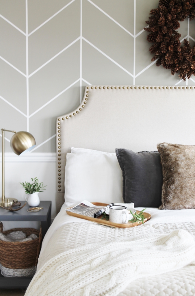 simple modern farmhouse holiday bedroom. Christmas decorating. Pine cone wreath, fresh greenery, plaid & cozy details