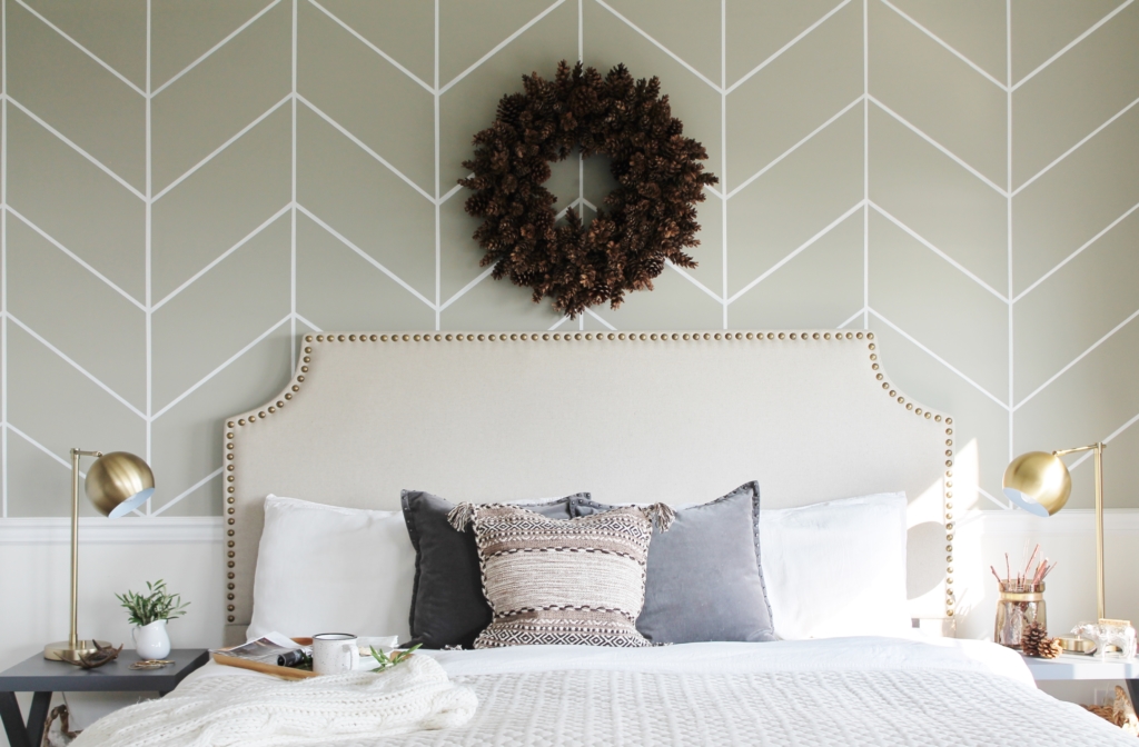 simple modern farmhouse holiday bedroom. Christmas decorating. Pine cone wreath, fresh greenery, plaid & cozy details