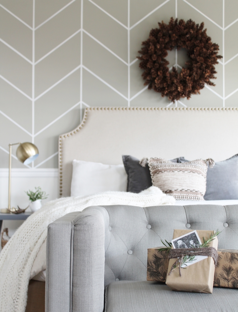 simple modern farmhouse holiday bedroom. Christmas decorating. Pine cone wreath, fresh greenery, plaid & cozy details