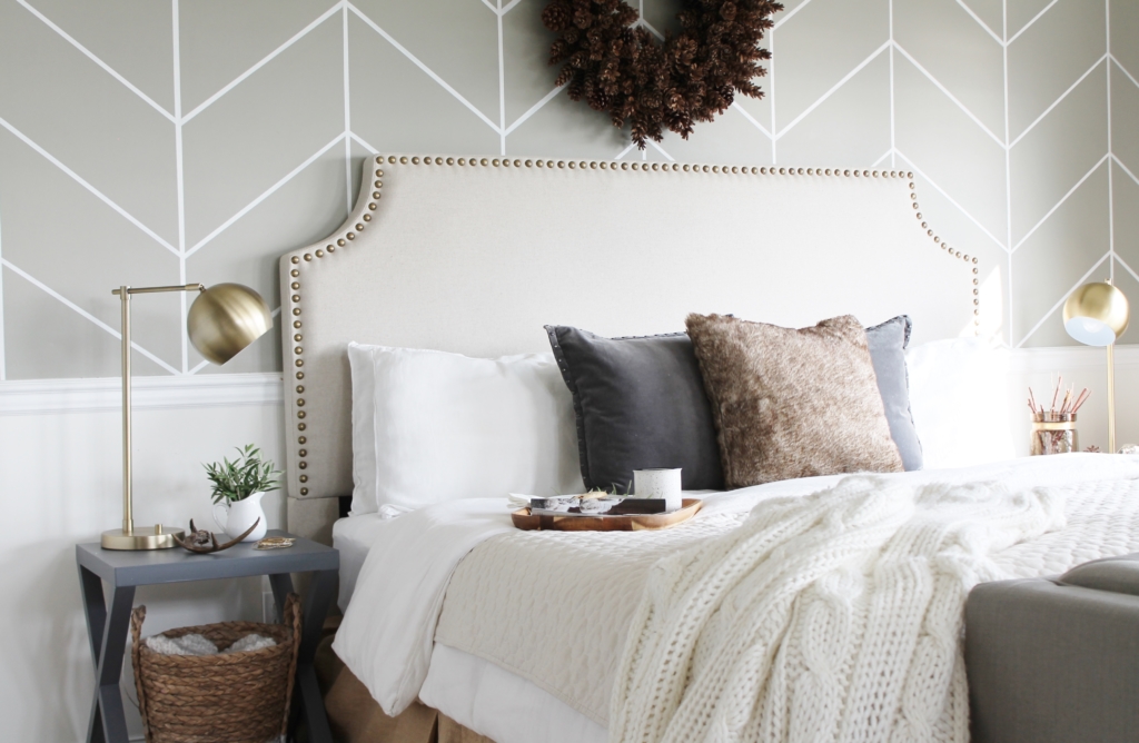 simple modern farmhouse holiday bedroom. Christmas decorating. Pine cone wreath, fresh greenery, plaid & cozy details