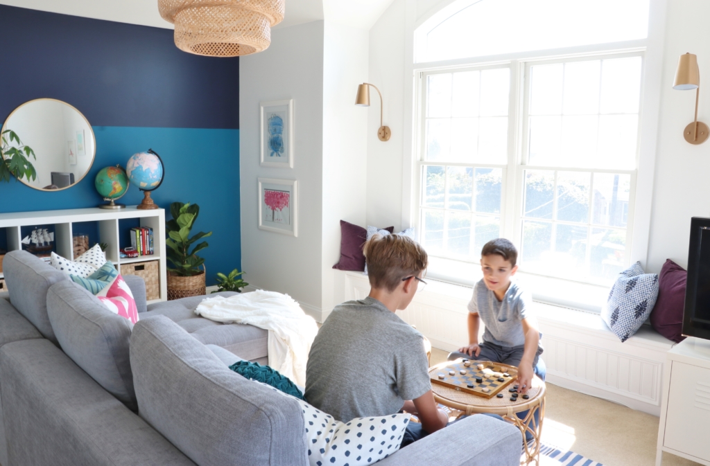 modern sofa bed-Soma by Article in Dawn Gray. Playroom updates including brass sconces & rattan pendant. Rattan side tables with navy striped rug.