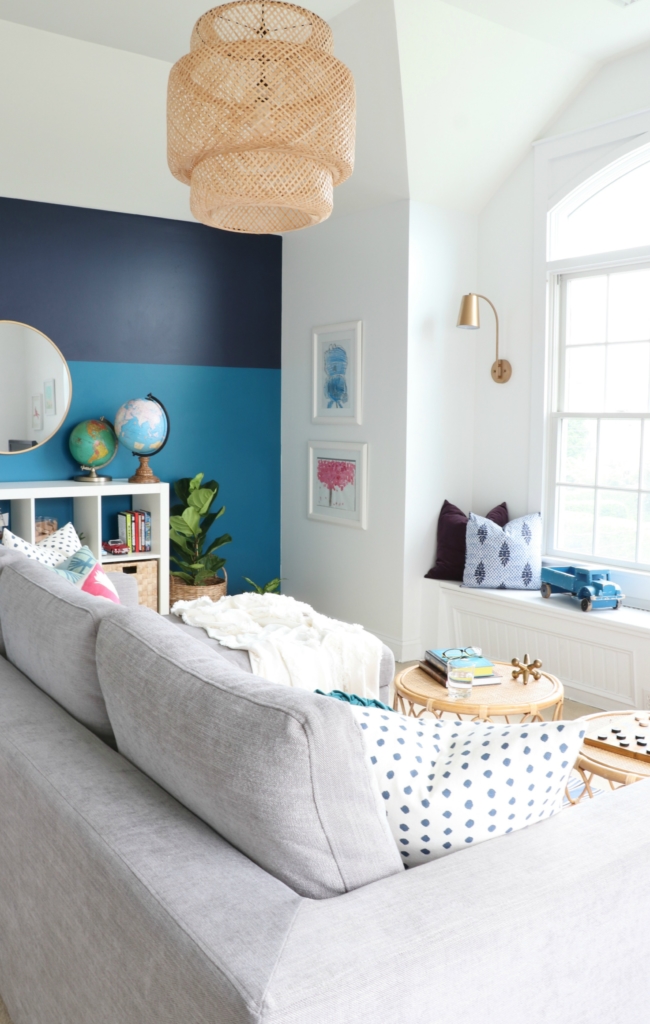 modern sofa bed-Soma by Article in Dawn Gray. Playroom updates including brass sconces & rattan pendant. Rattan side tables with navy striped rug.