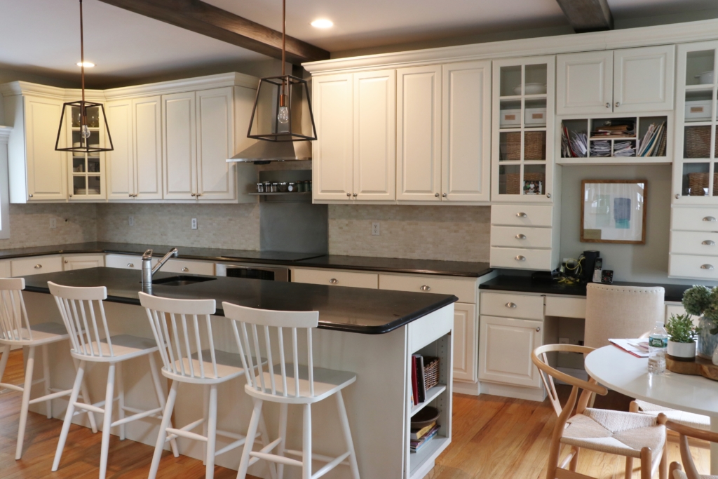 White Kitchen Renovation. HanStone Quartz, Montauk. White painted cabinets, black hardware