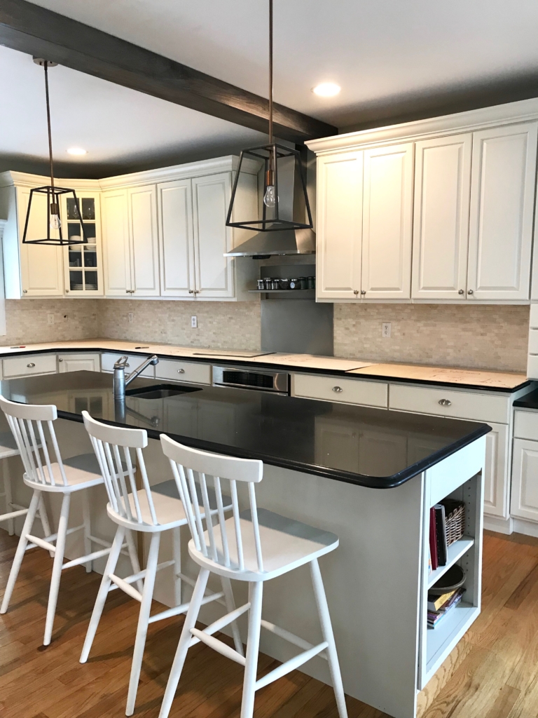 White Kitchen Renovation. HanStone Quartz, Montauk. White painted cabinets, black hardware