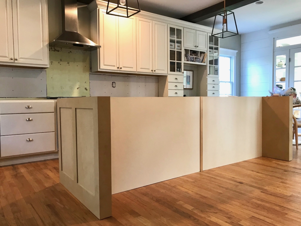 White Kitchen Renovation. HanStone Quartz, Montauk. White painted cabinets, black hardware