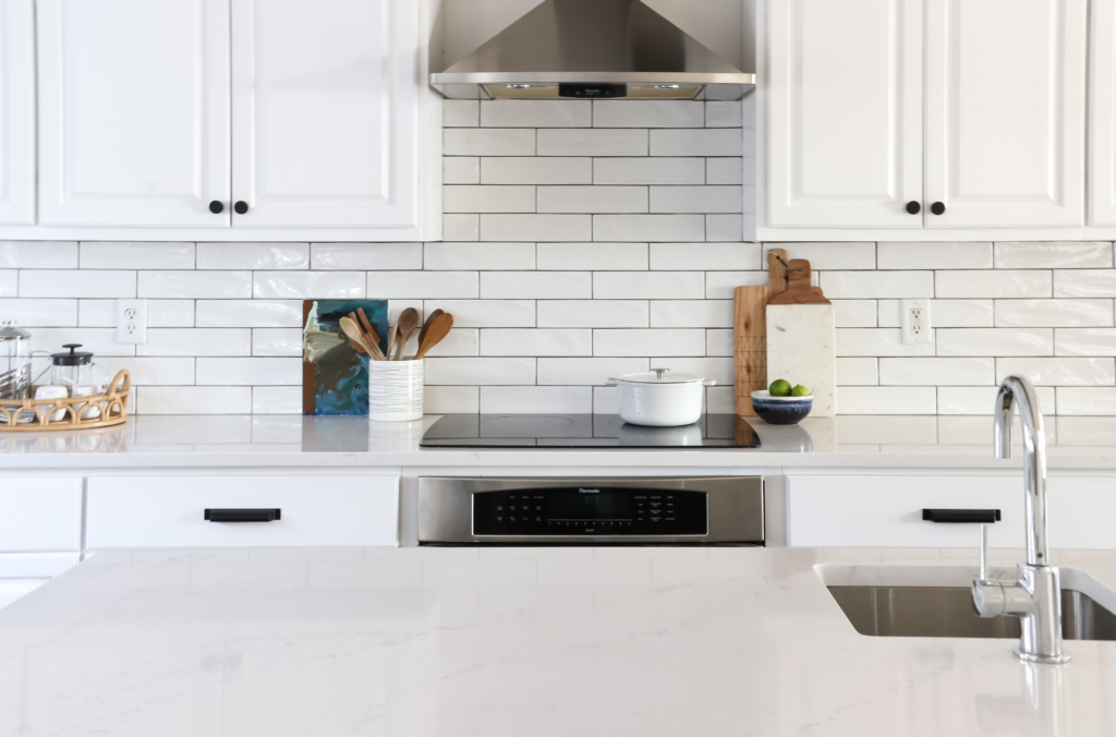 White Kitchen Reveal-HanStone Quartz in Montauk-Chantilly Lace-Cast Iron-White Cabinets-Wood Beams-Budget Friendly Kitchen Renovation-Earthy Coastal Kitchen Makeover