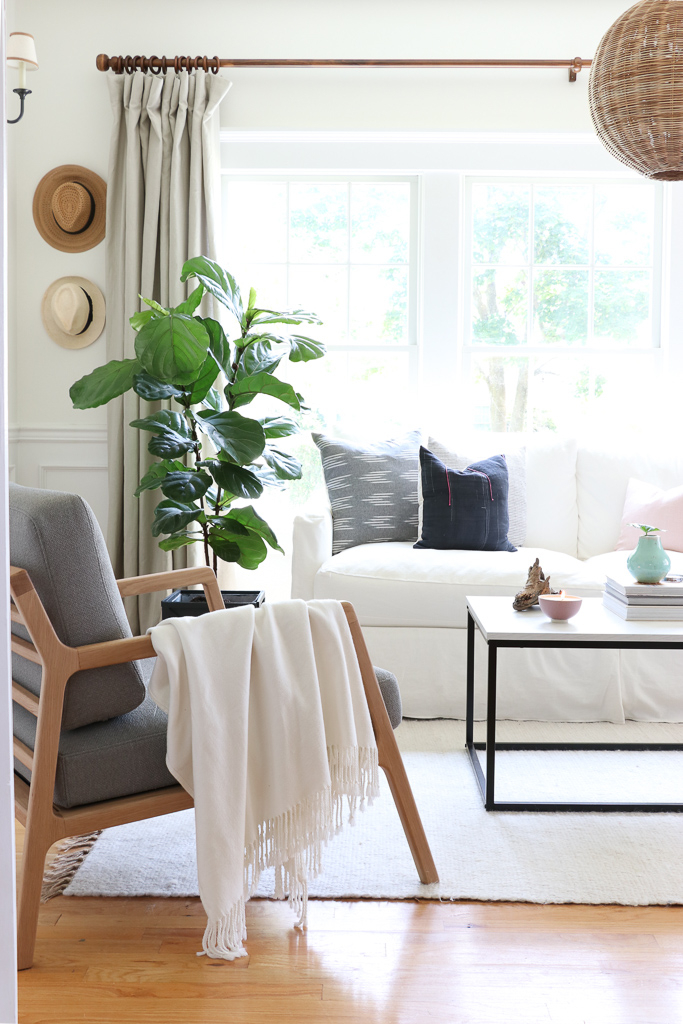 Denman Chair Article, White Slipcovered sofa, Woven Shade, White Walls, City Farmhouse & Co Pillows, Hats on Wall, Indigo Pillows