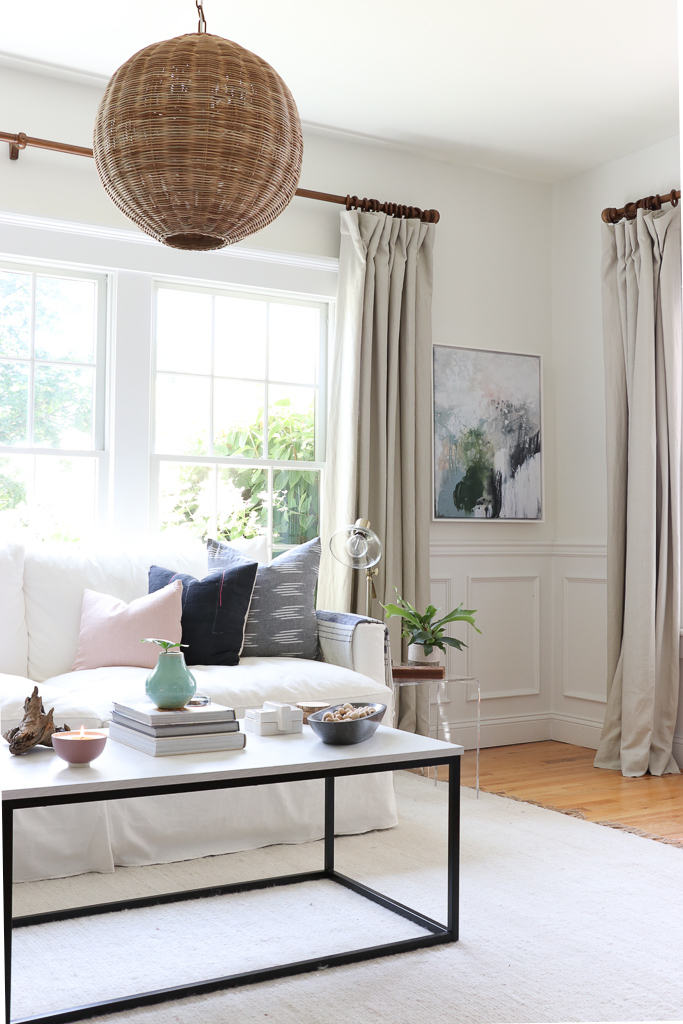 Denman Chair Article, White Slipcovered sofa, Woven Shade, White Walls, City Farmhouse & Co Pillows, Hats on Wall, Indigo Pillows, Lindsay Letters Art