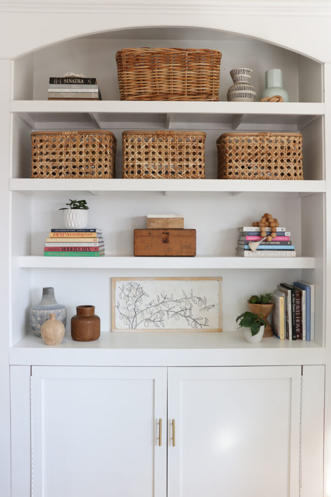White built-ins with modern coastal vibe and cane baskets.