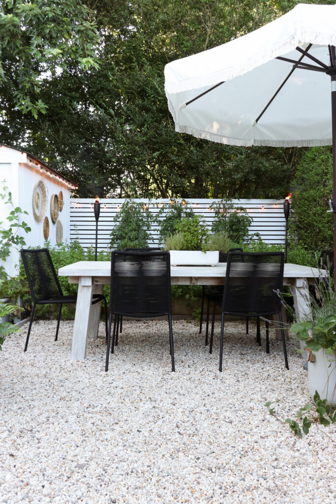 California Casual, Palm Springs Inspired Pea Gravel Patio. Zina Outdoor dining chairs from Article.