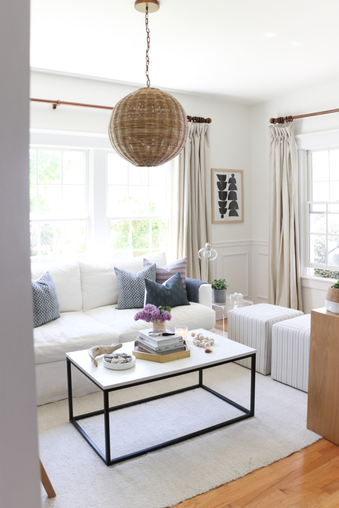 City Farmhouse Spring den. Pure White walls and white slipcovered sofa.