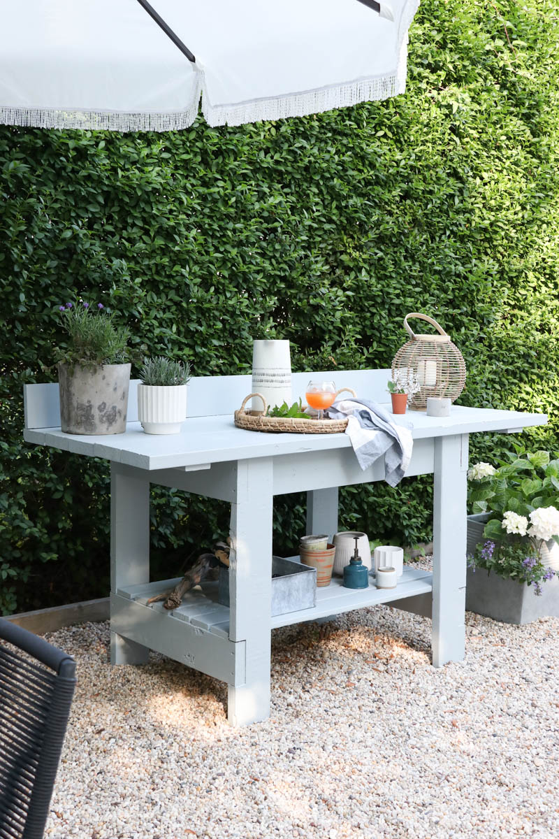 City Farmhouse by Jennifer OBrien. Free workbench turned into potting bench + outdoor bar. DIY pea gravel patio. Boothbay Gray by Benjamin Moore.