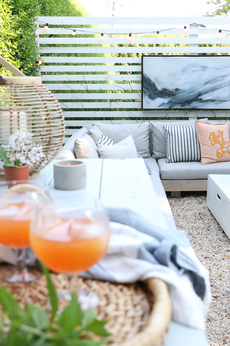 City Farmhouse by Jennifer OBrien. Free workbench turned into potting bench + outdoor bar. DIY pea gravel patio. Boothbay Gray by Benjamin Moore.