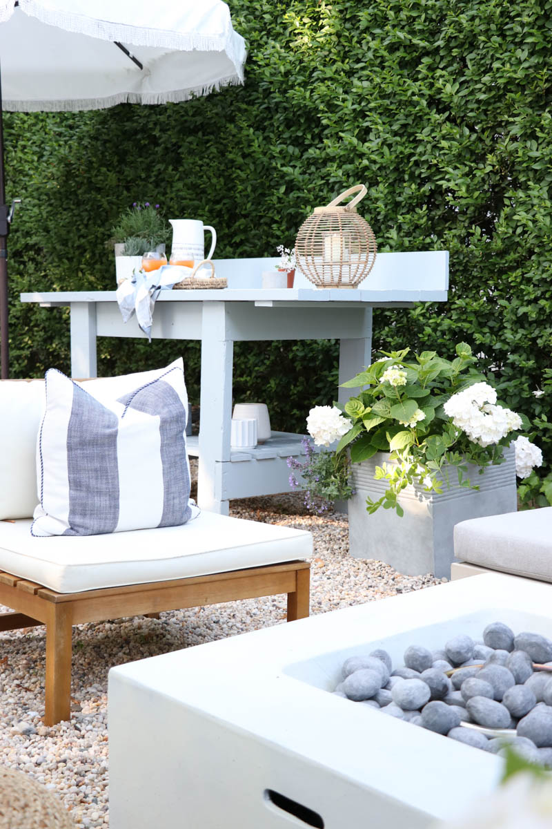 City Farmhouse by Jennifer OBrien. Free workbench turned into potting bench + outdoor bar. DIY pea gravel patio. Boothbay Gray by Benjamin Moore.