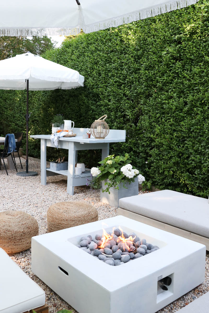 City Farmhouse by Jennifer OBrien. Free workbench turned into potting bench + outdoor bar. DIY pea gravel patio. Boothbay Gray by Benjamin Moore.