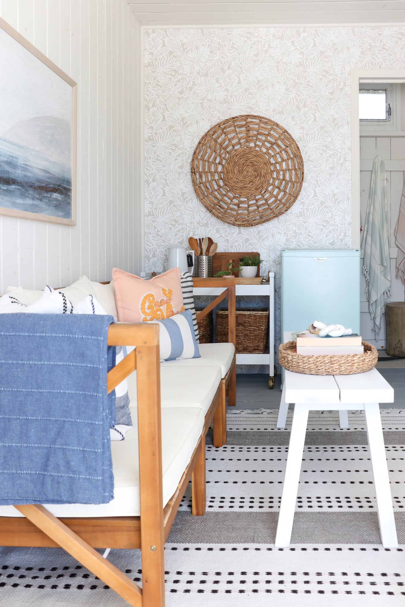 Beach Cabana Makeover With botanical wallpaper, striped rug, Ikea bench and blue refrigerator. 