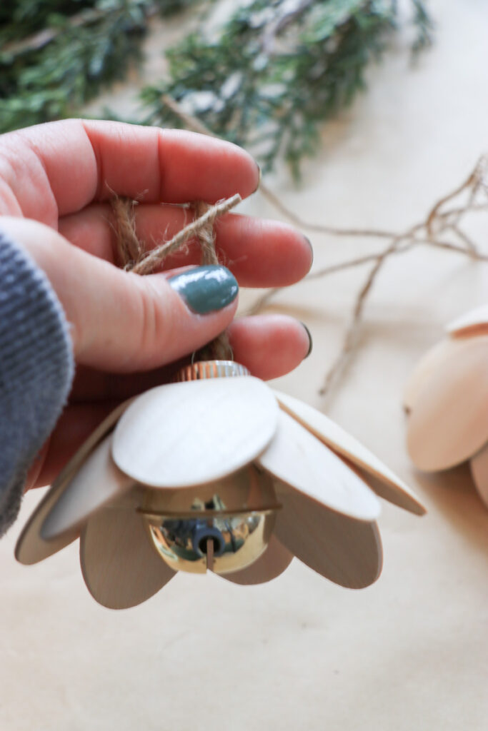 DIY Christmas bells for your mantel, wreath, staircase, or tree. You'll need 8 wooden spoons per bell and a round ornament to make these Lotus Bells. 