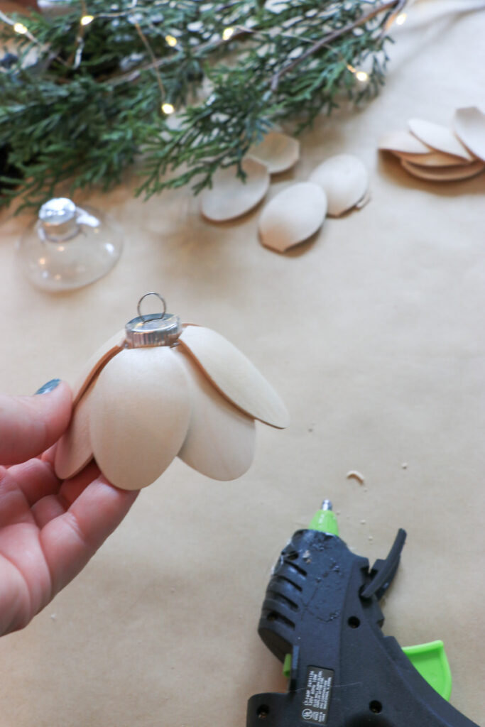 DIY Christmas bells for your mantel, wreath, staircase, or tree. You'll need 8 wooden spoons per bell and a round ornament to make these Lotus Bells. 