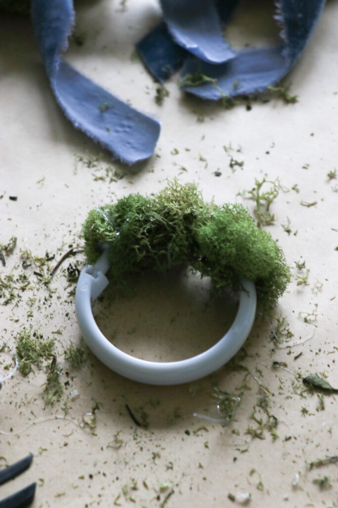 Mini Moss Wreaths-The Perfect Christmas Craft with moss from the craft store, a shower curtain ring, and ribbon.
